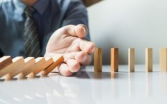 businessman-hand-stop-dominoes-continuous-toppled-risk-with-copyspace